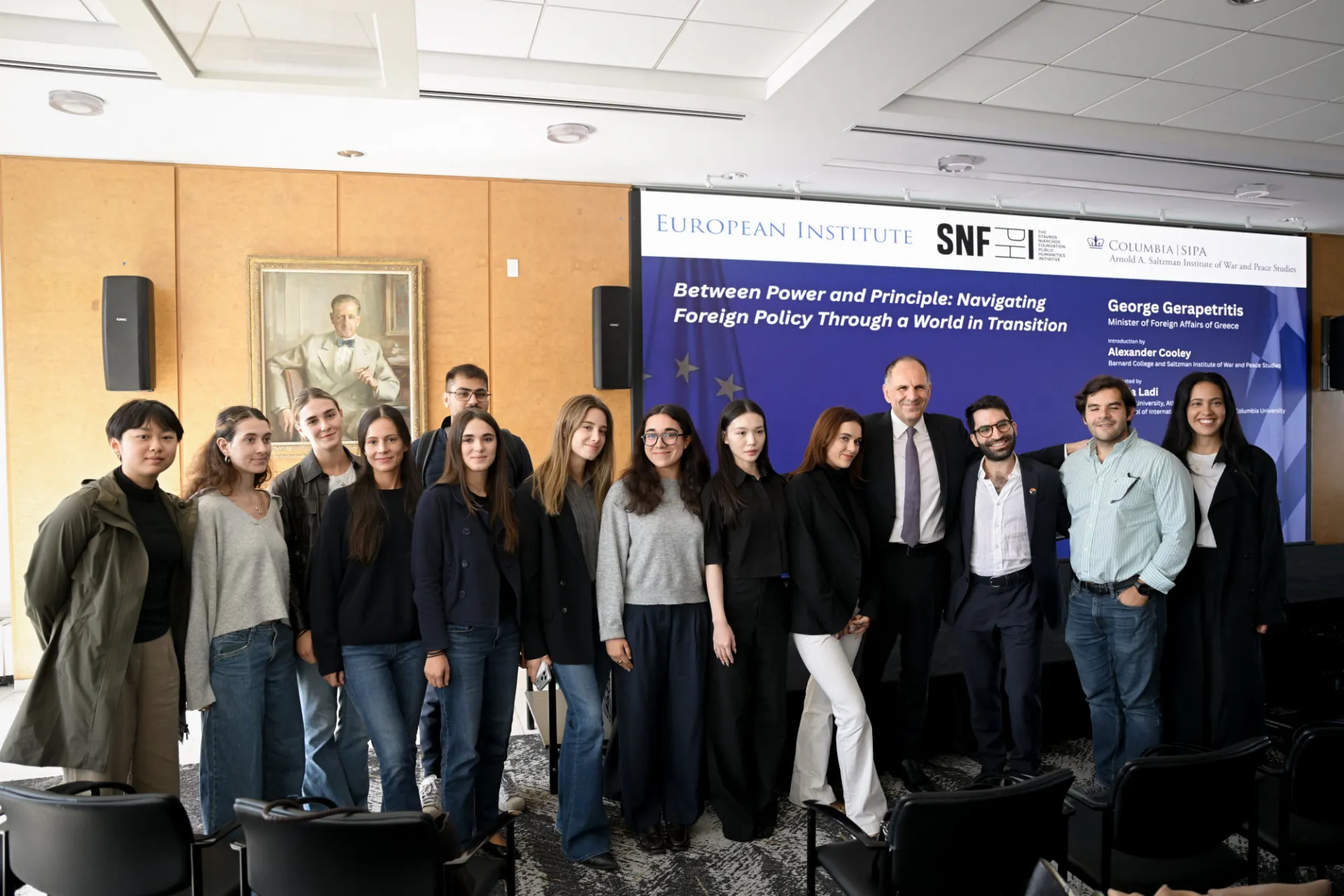 George Gerapetritis smiles with students for a photo.