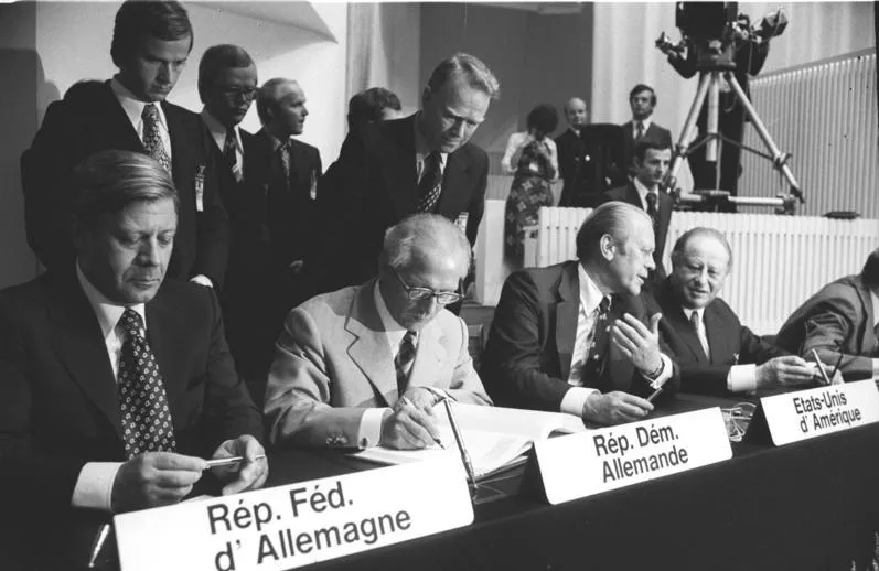Photo of dignitaries signing documents at the Helsinki Security Conference 1975
